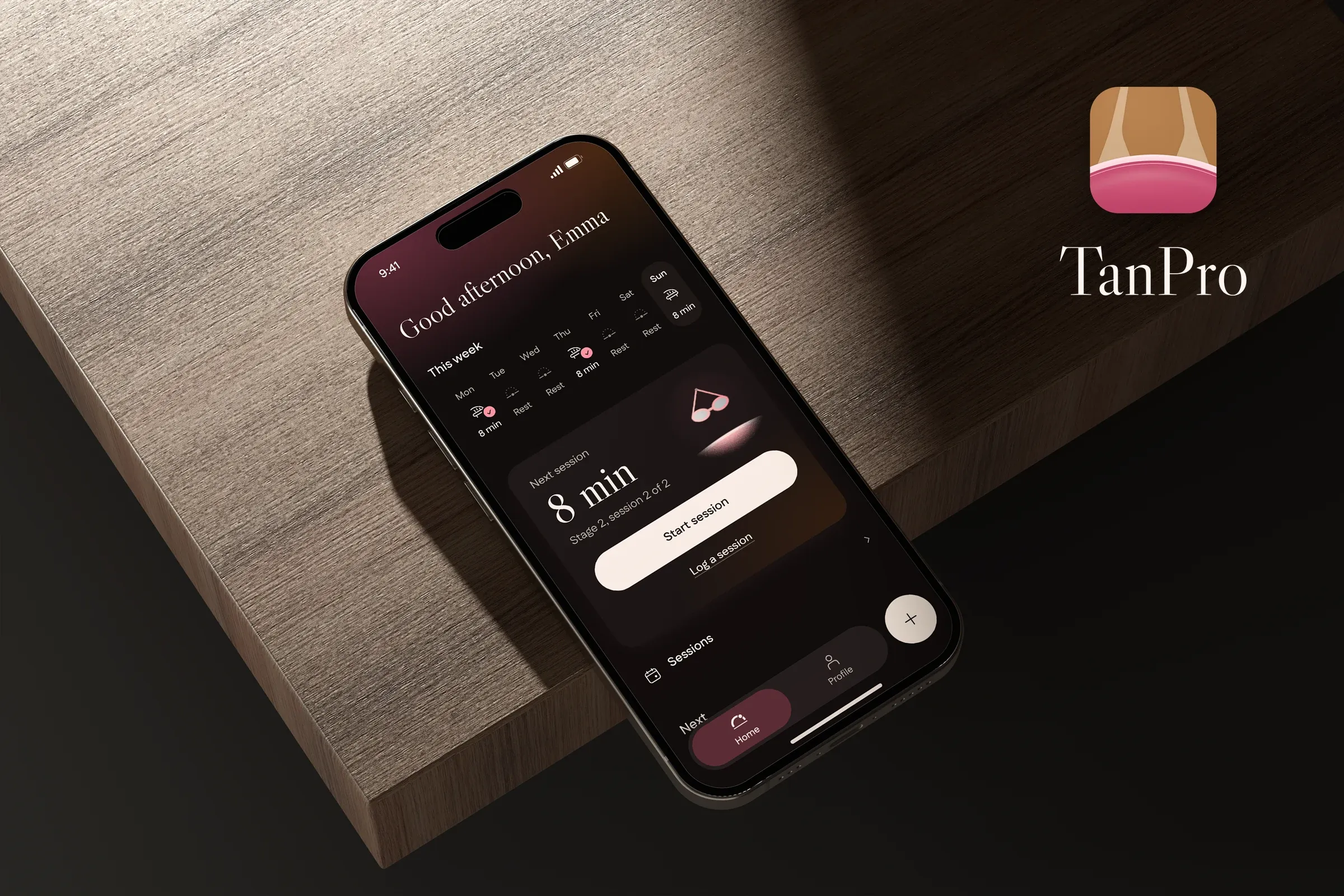 TanPro's home screen in dark mode on a phone on dark wood, with the TanPro logo